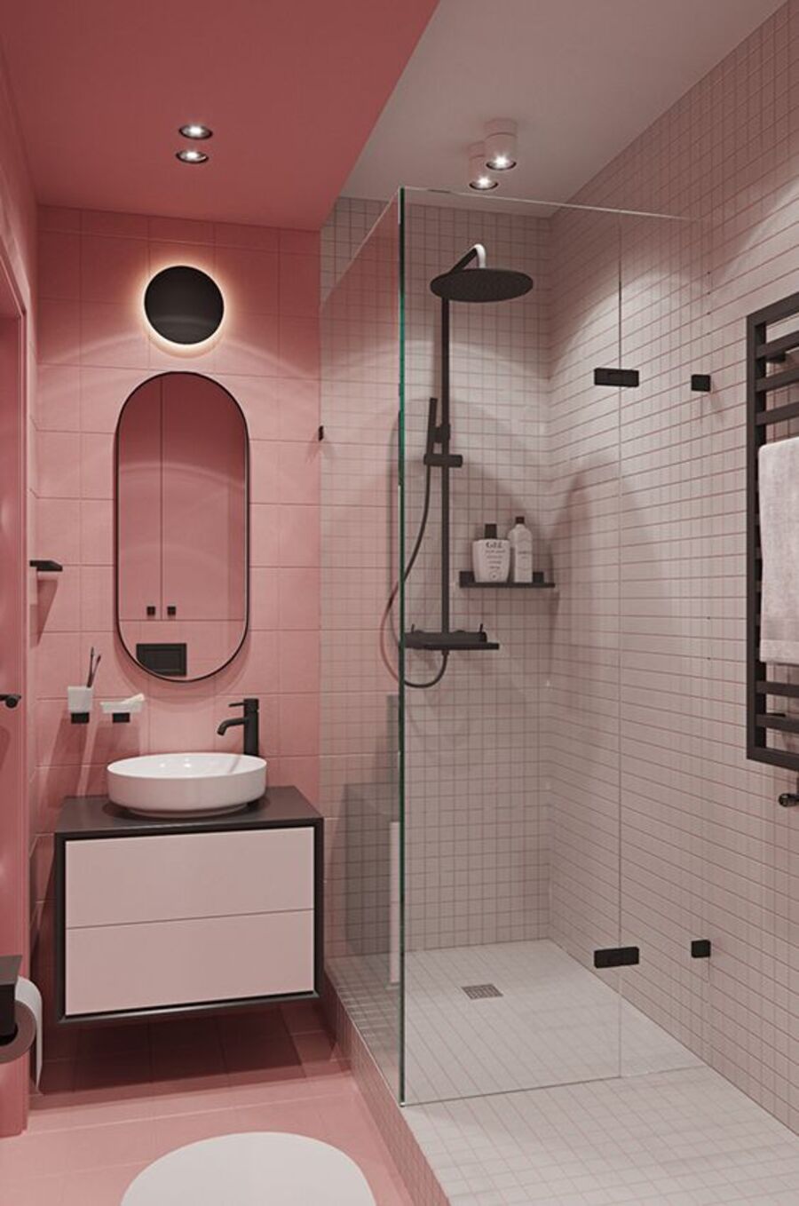 Baño con paredes y piso rosado. En la otra mitad del baño hay una ducha con azulejos blancos y grifería negra.