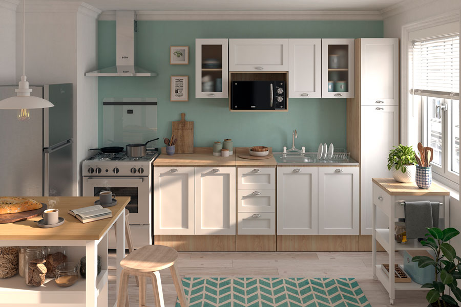 Imagen de una cocina abierta con muebles blancos, cubierta de madera y tiradores metálicos. La pared es color turquesa claro, al igual que la alfombra. Las islas de cocina también son blancas con superficie de madera clara.